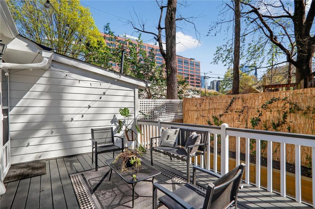 1267 Lyle Place Northwest Atlanta, GA 30318 - Photo 14 of 15 a view of balcony with wooden floor outdoor seating and yard in the back
