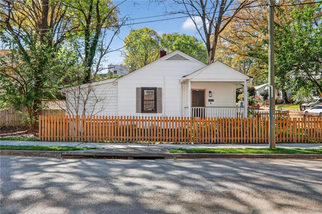 1267 Lyle Place Northwest Atlanta, GA 30318 - Photo 15 of 15 a view of a house with a small yard and large trees