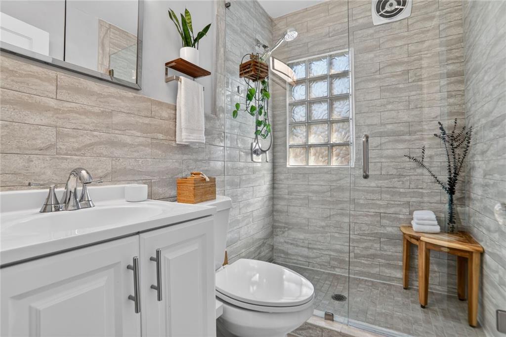 1267 Lyle Place Northwest Atlanta, GA 30318 - Photo 10 of 15 a bathroom with a sink a toilet and shower