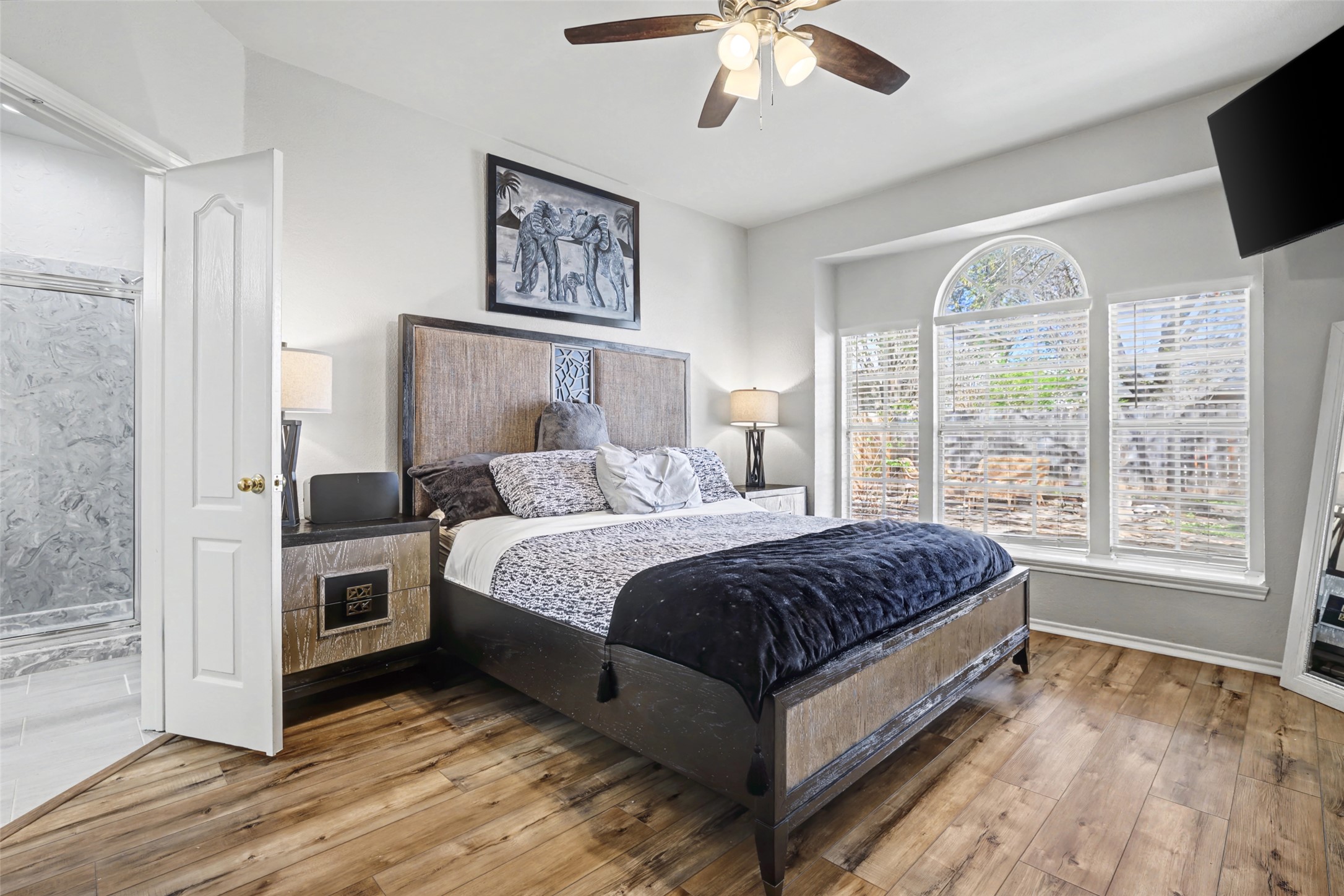1109 Pebble Brook Road Cedar Park, TX 78613 - Photo 17 of 40 Bedroom featuring light wood-type flooring, ceiling fan, and connected bathroom