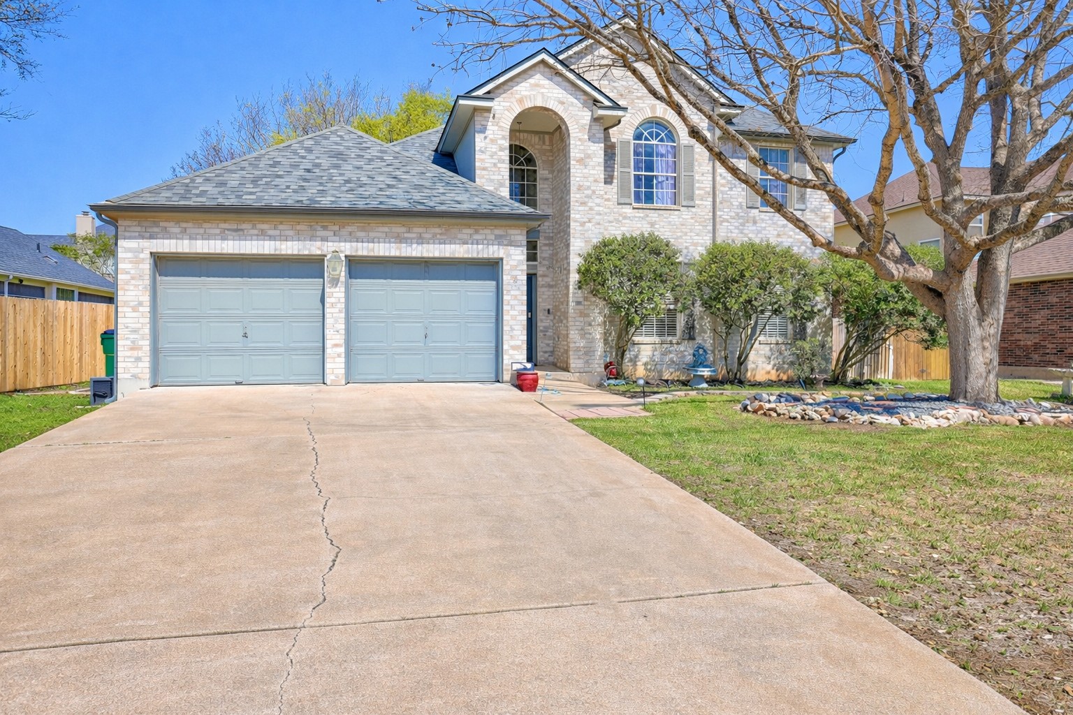 1109 Pebble Brook Road Cedar Park, TX 78613 - Photo 2 of 40 View of front of house with brick siding, driveway, a garage, and roof with shingles