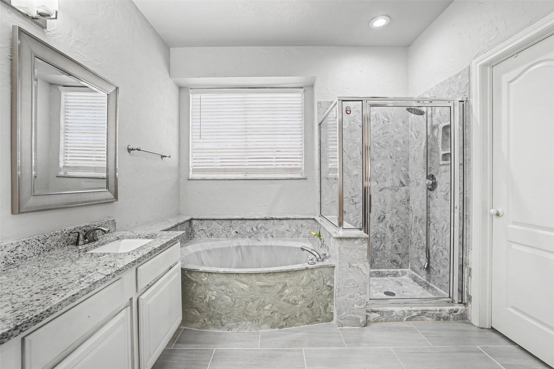1109 Pebble Brook Road Cedar Park, TX 78613 - Photo 21 of 40 Bathroom with a marble finish shower, vanity, a bath, and a textured wall