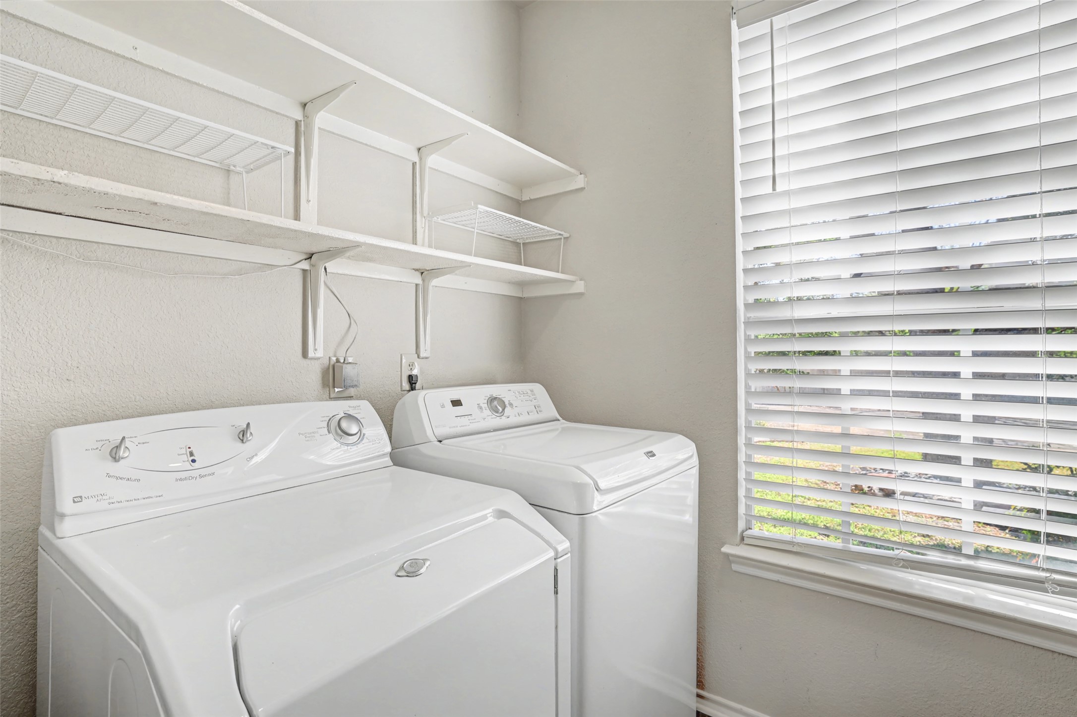 1109 Pebble Brook Road Cedar Park, TX 78613 - Photo 33 of 40 Laundry area with washing machine and dryer and a textured wall