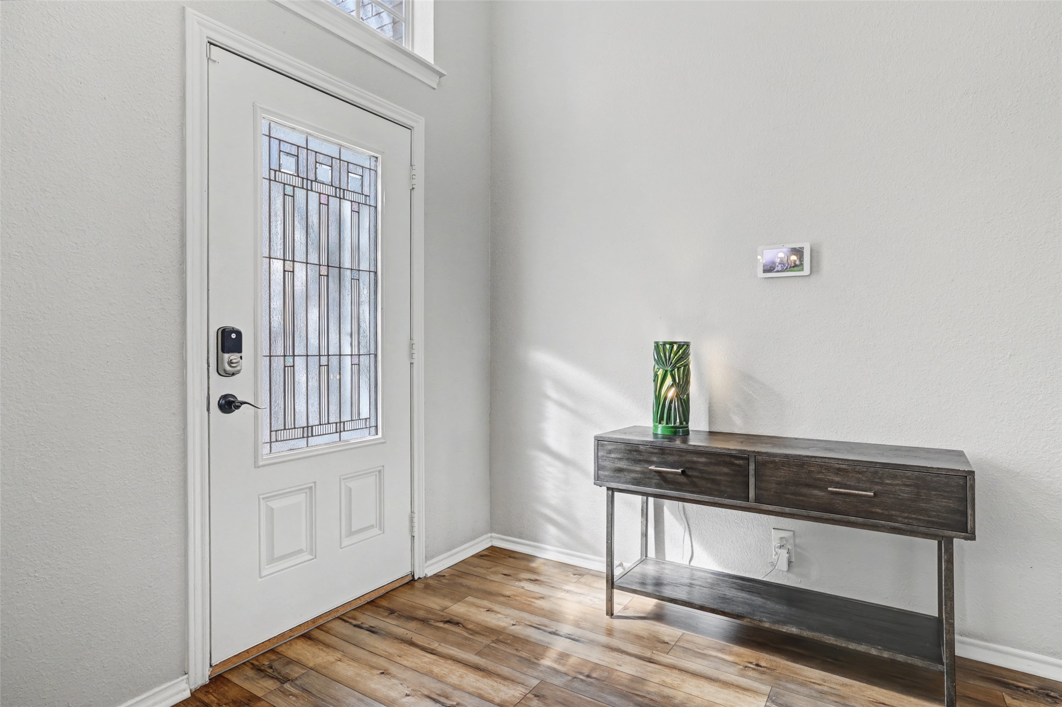1109 Pebble Brook Road Cedar Park, TX 78613 - Photo 4 of 40 Entryway featuring light wood-style flooring and a textured wall