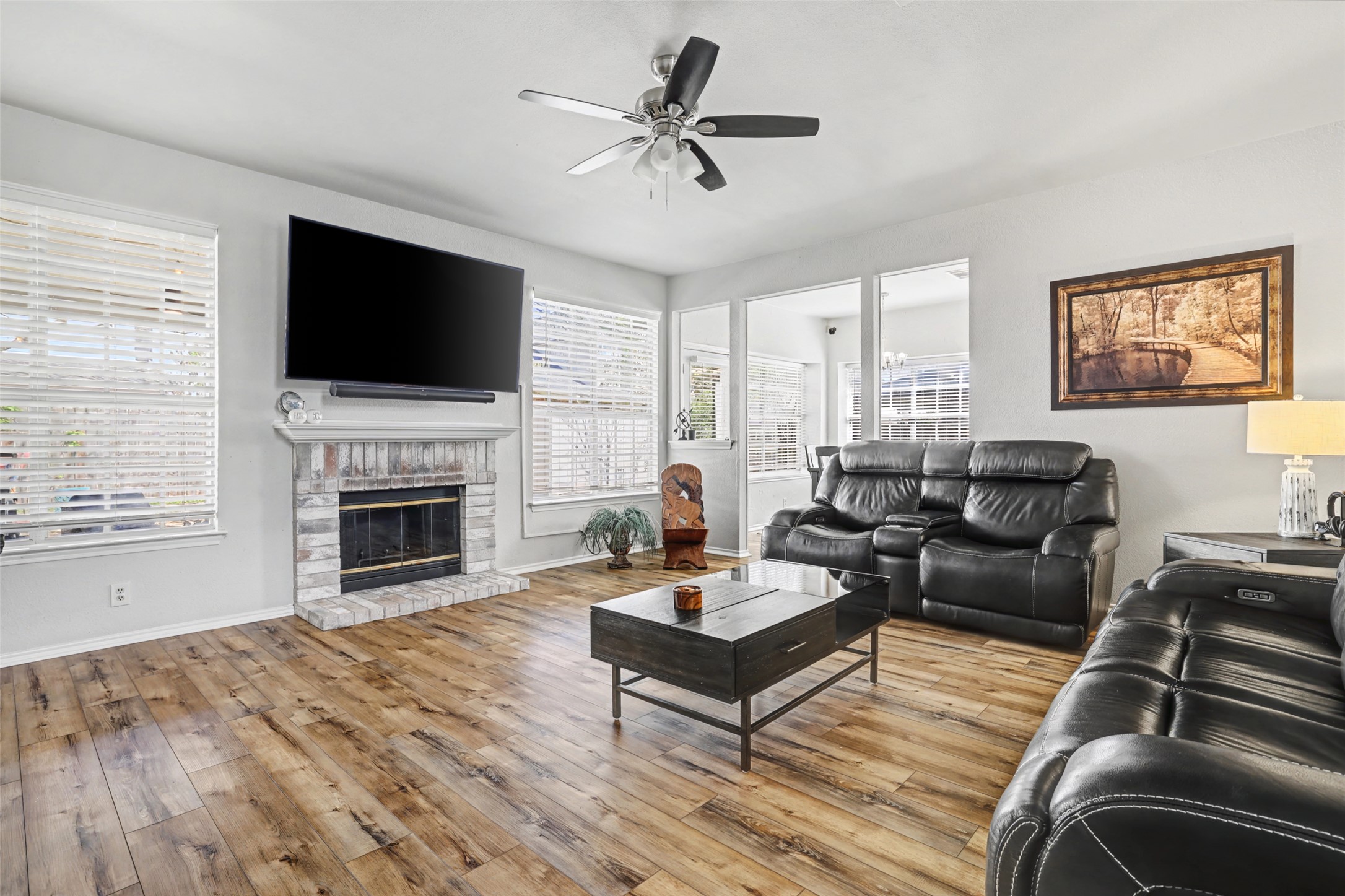 1109 Pebble Brook Road Cedar Park, TX 78613 - Photo 9 of 40 Living room featuring light wood-style floors, a ceiling fan, and a fireplace