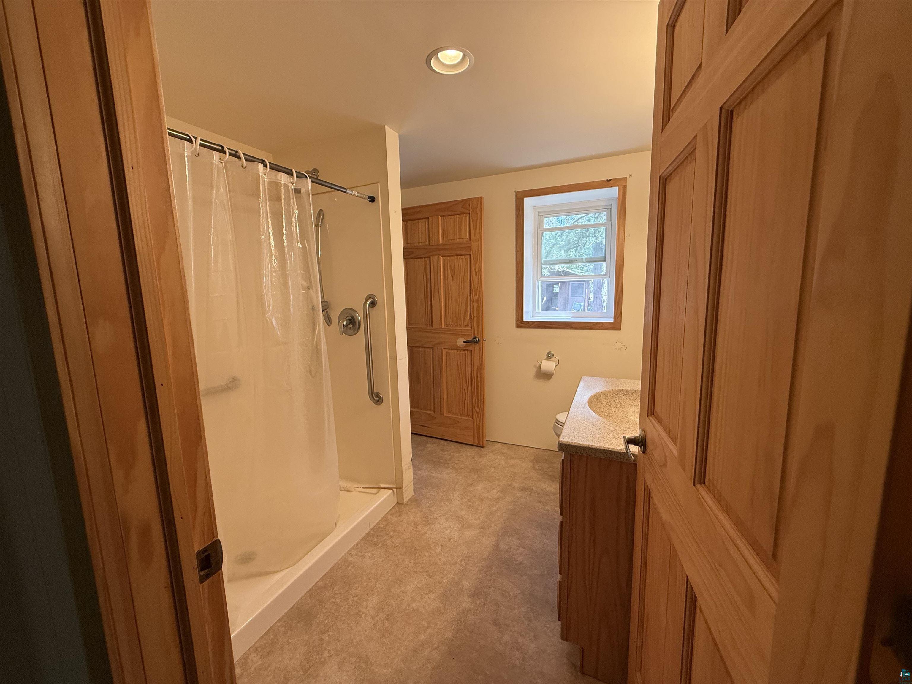 7620 County Rd T Wascott, WI 54859 - Photo 11 of 17 Full bath featuring vanity, a shower stall, and recessed lighting