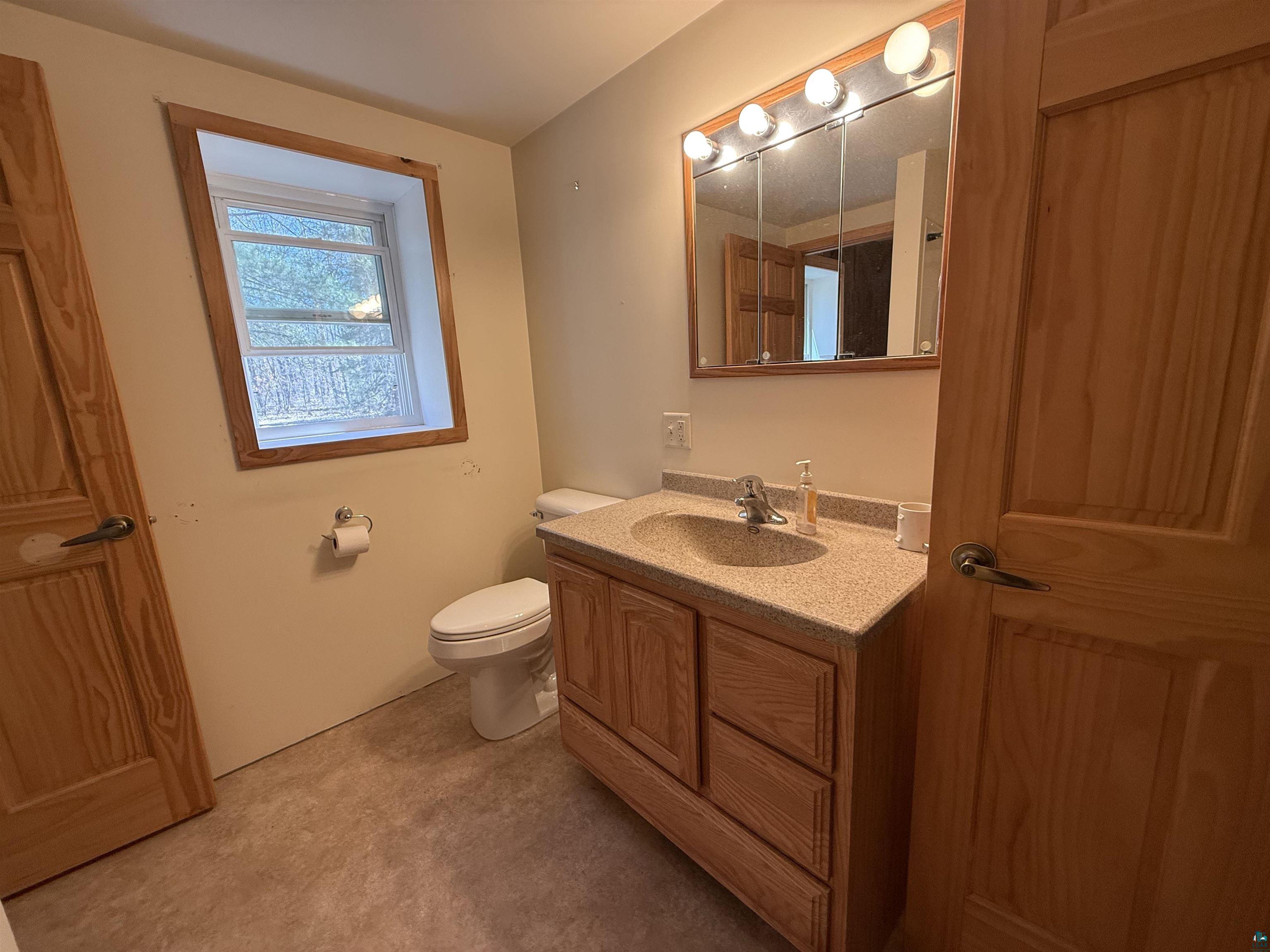 7620 County Rd T Wascott, WI 54859 - Photo 10 of 17 Bathroom with vanity and toilet