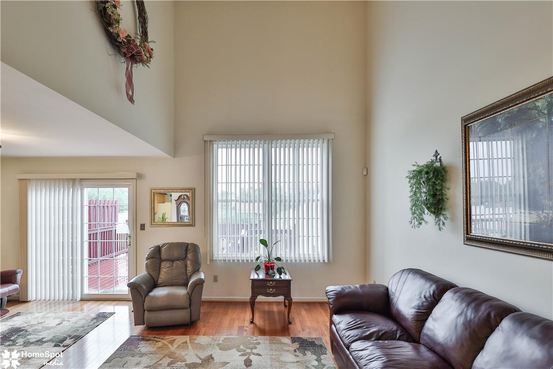 507 Howertown Road Northampton, PA 18067 - Photo 10 of 46 A living space showcasing rich hardwood flooring and sun-filled windows.