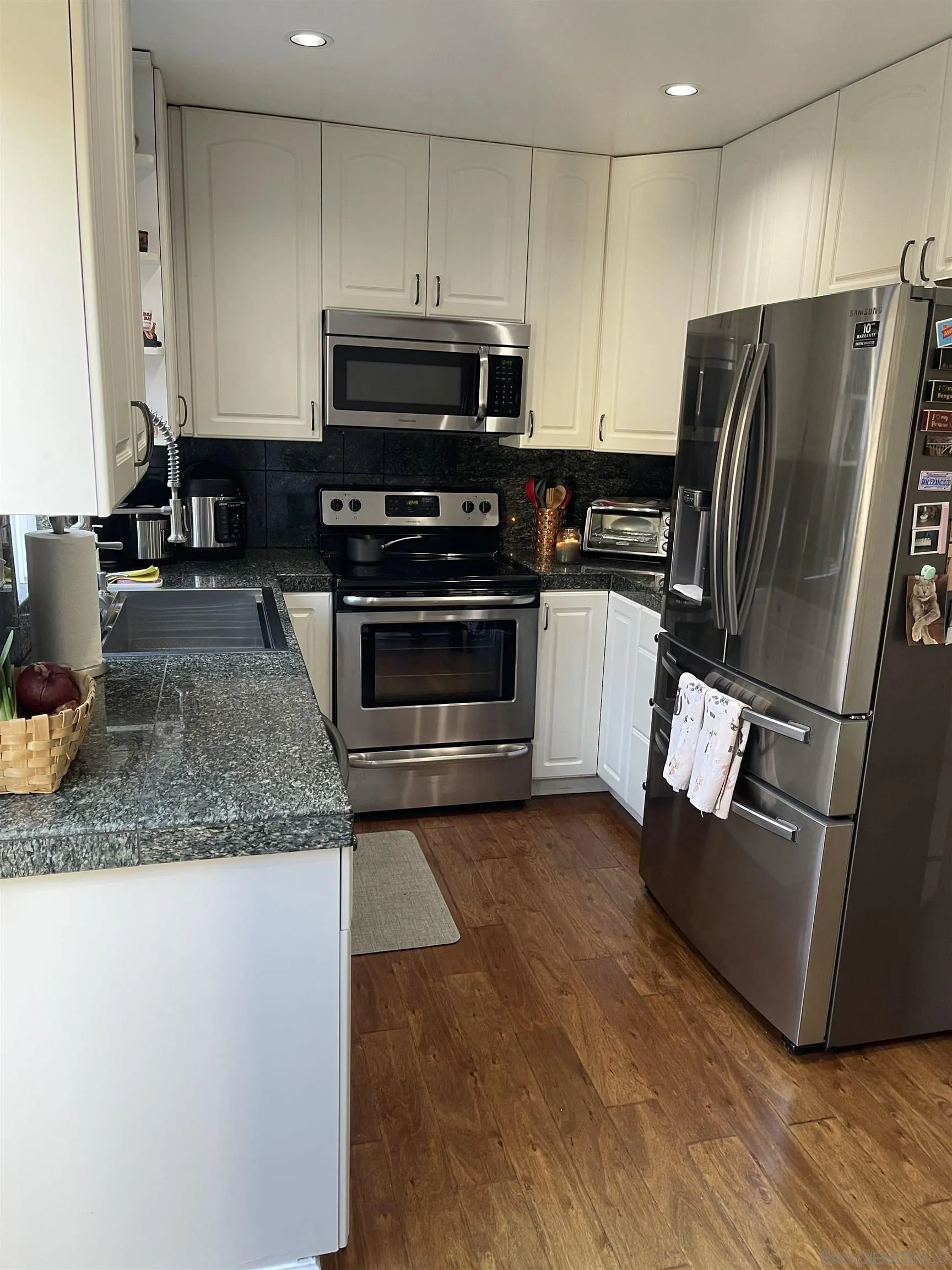 10306 Leila Lane Santee, CA 92071 - Photo 13 of 31 a kitchen with a refrigerator sink and microwave