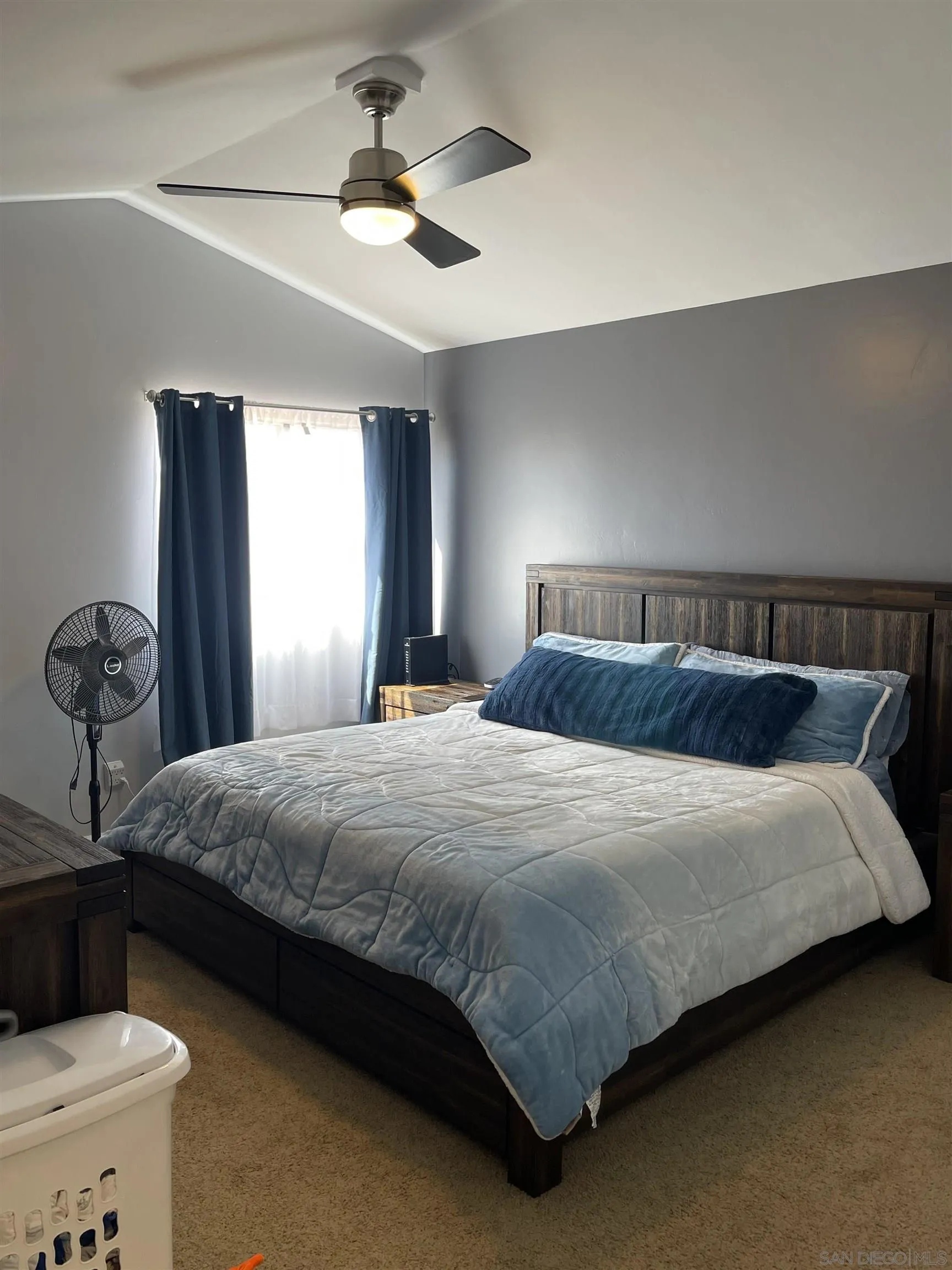 10306 Leila Lane Santee, CA 92071 - Photo 22 of 31 a bedroom with a bed and a chandelier