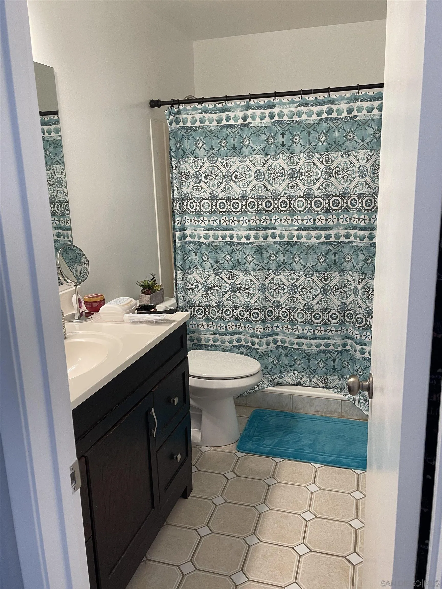 10306 Leila Lane Santee, CA 92071 - Photo 23 of 31 a bathroom with a granite countertop sink toilet and shower