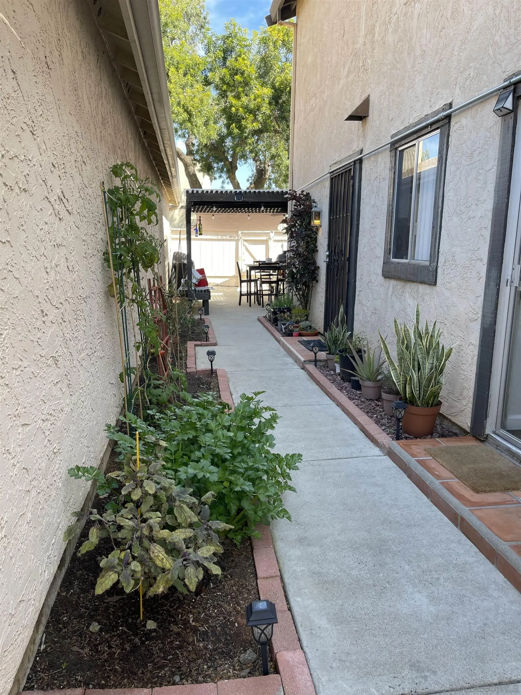 10306 Leila Lane Santee, CA 92071 - Photo 4 of 31 a potted plant sitting in front of a building