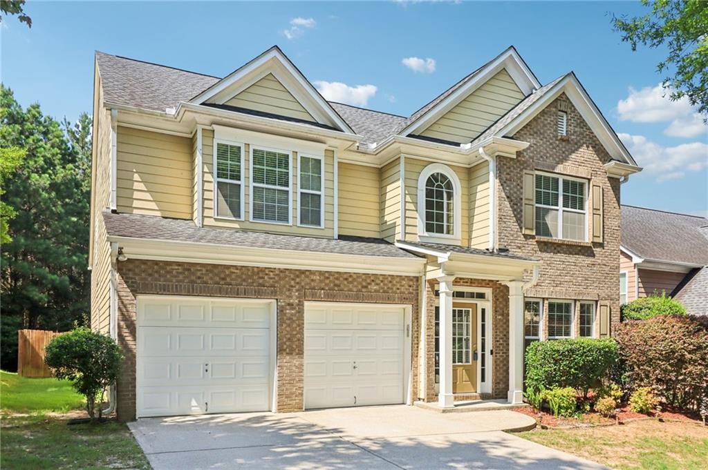 1755 Rutland Pass Drive Southeast Lawrenceville, GA 30045 - Photo 1 of 1 a front view of a house with a yard and garage