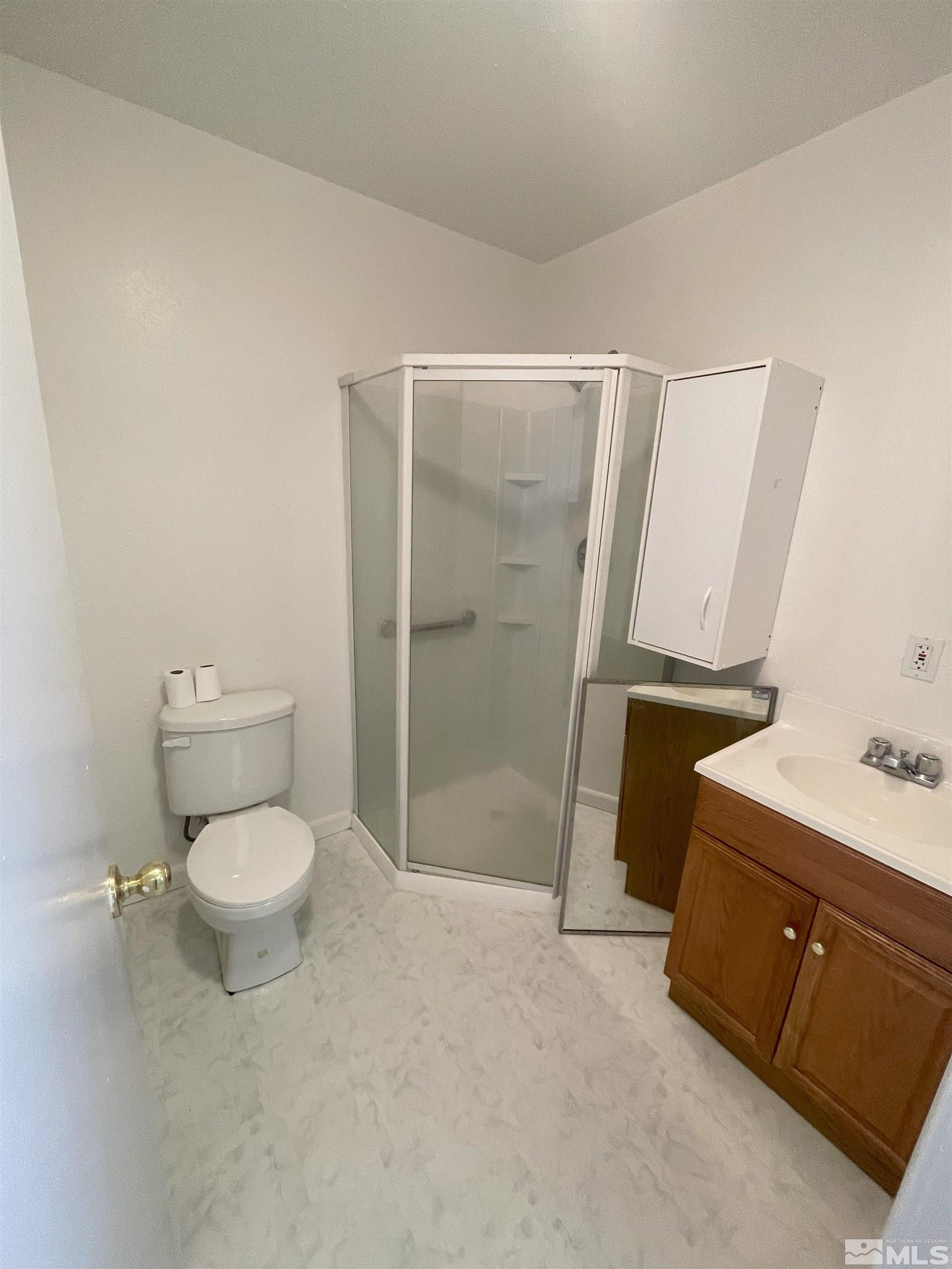 15064 North Red Rock Road Reno, NV 89508 - Photo 34 of 40 a bathroom with a toilet a sink and shower