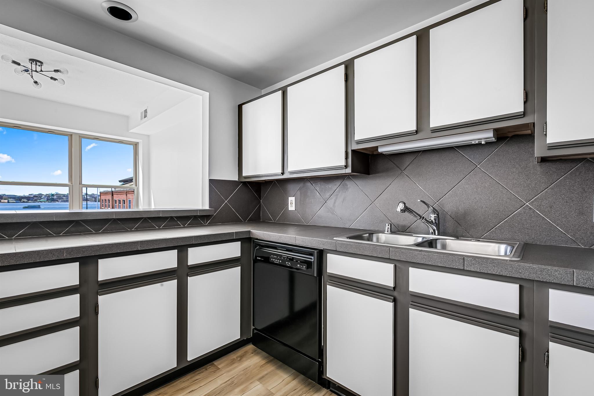 960 Fell Street, Unit 311 Baltimore, MD 21231 - Photo 12 of 59 a kitchen with stainless steel appliances granite countertop a sink stove and cabinets