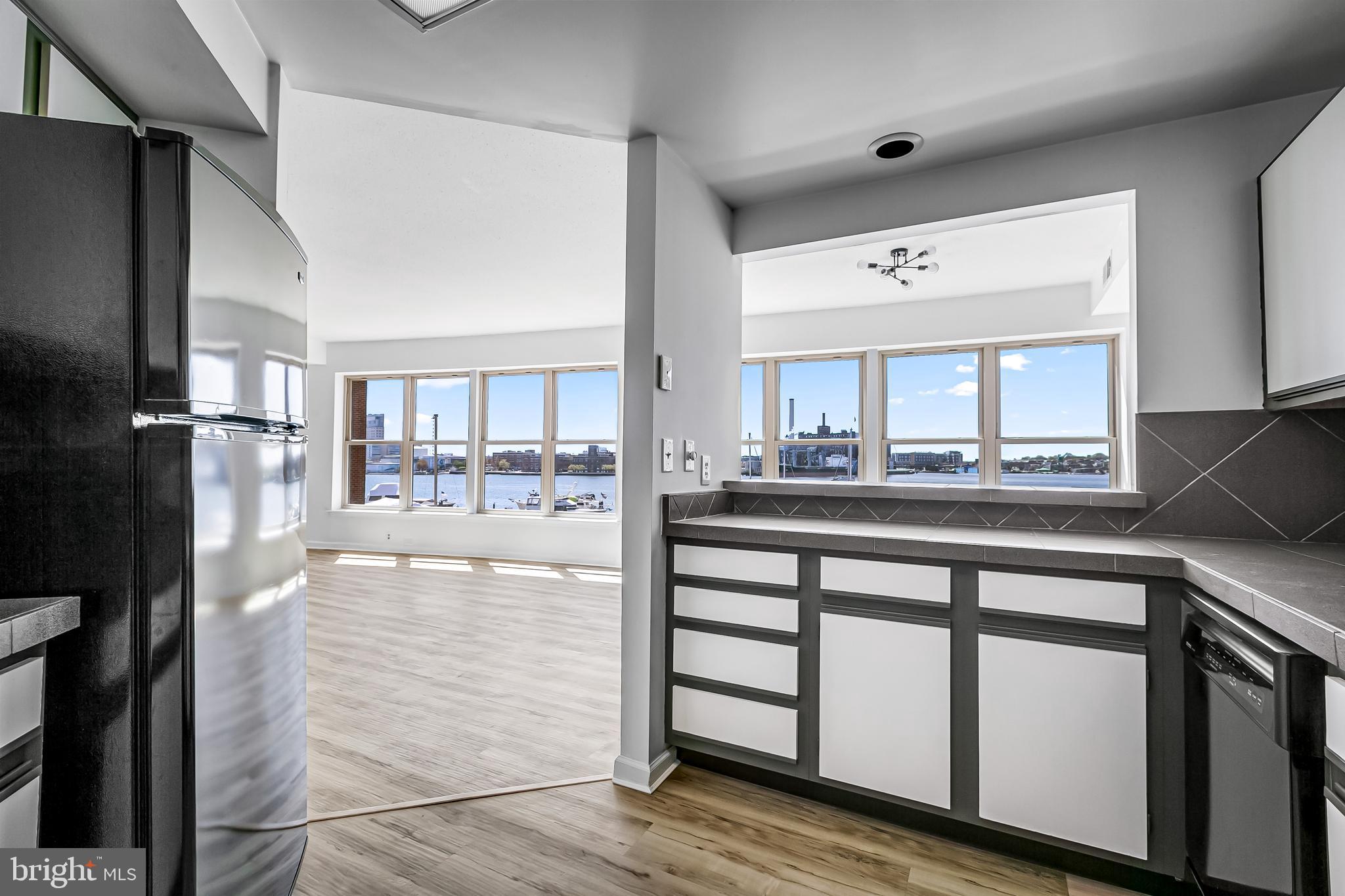 960 Fell Street, Unit 311 Baltimore, MD 21231 - Photo 14 of 59 a kitchen with stainless steel appliances granite countertop a refrigerator and cabinets