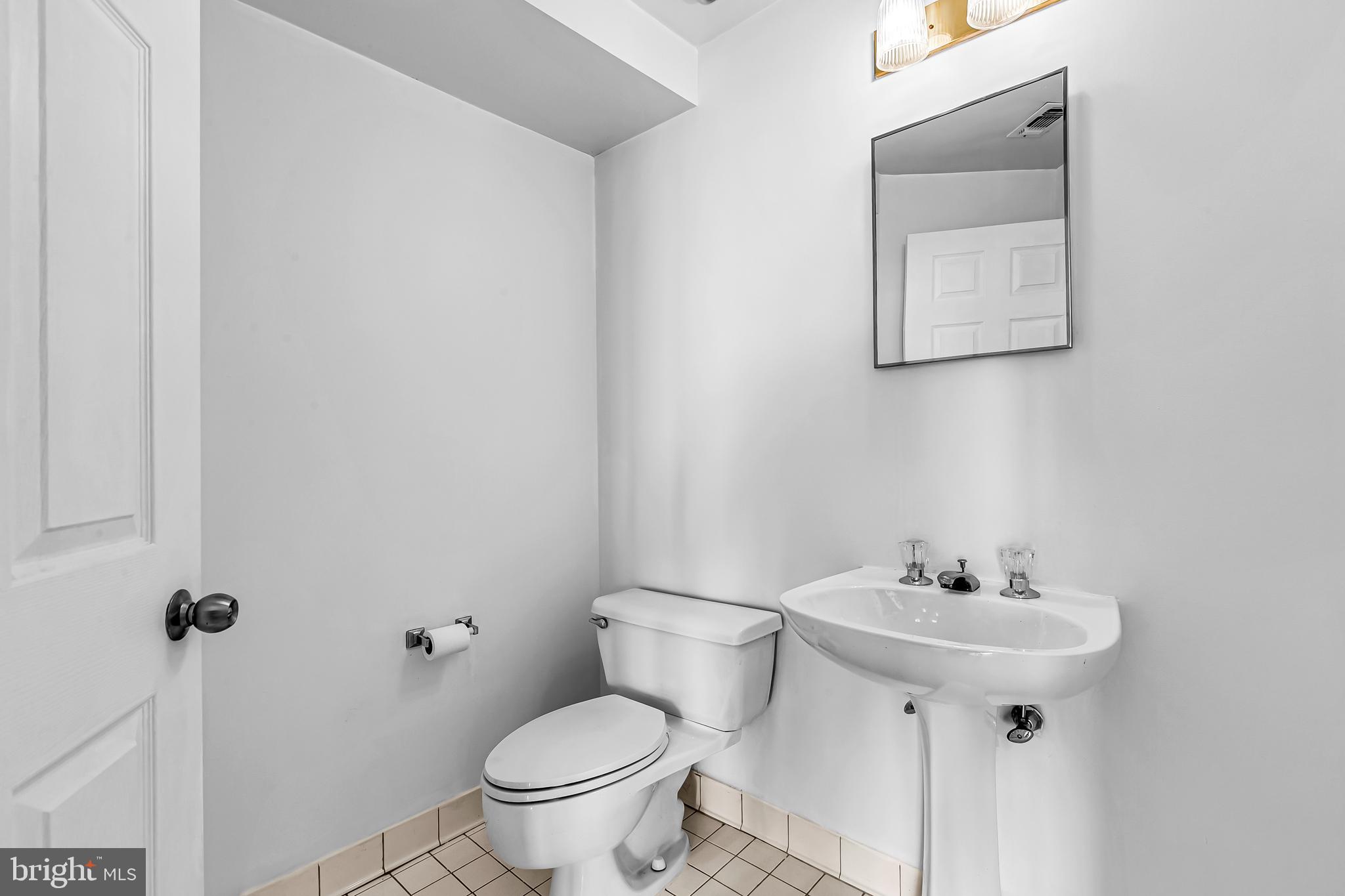 960 Fell Street, Unit 311 Baltimore, MD 21231 - Photo 15 of 59 a bathroom with a sink toilet and a mirror