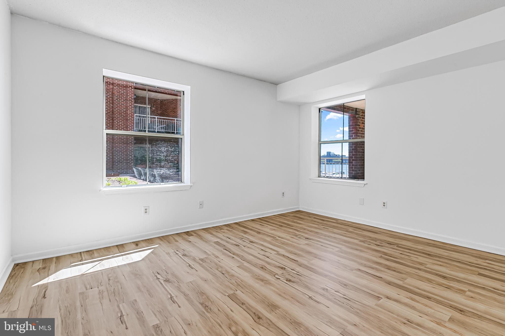 960 Fell Street, Unit 311 Baltimore, MD 21231 - Photo 16 of 59 a view of empty room with wooden floor and fan