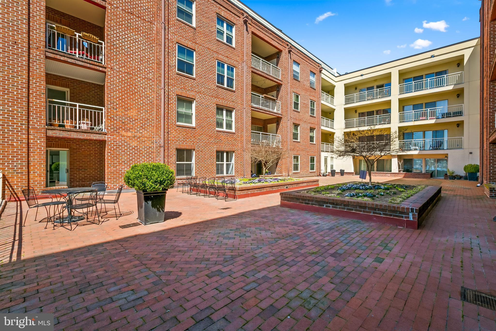 960 Fell Street, Unit 311 Baltimore, MD 21231 - Photo 32 of 59 a front view of a building with a garden