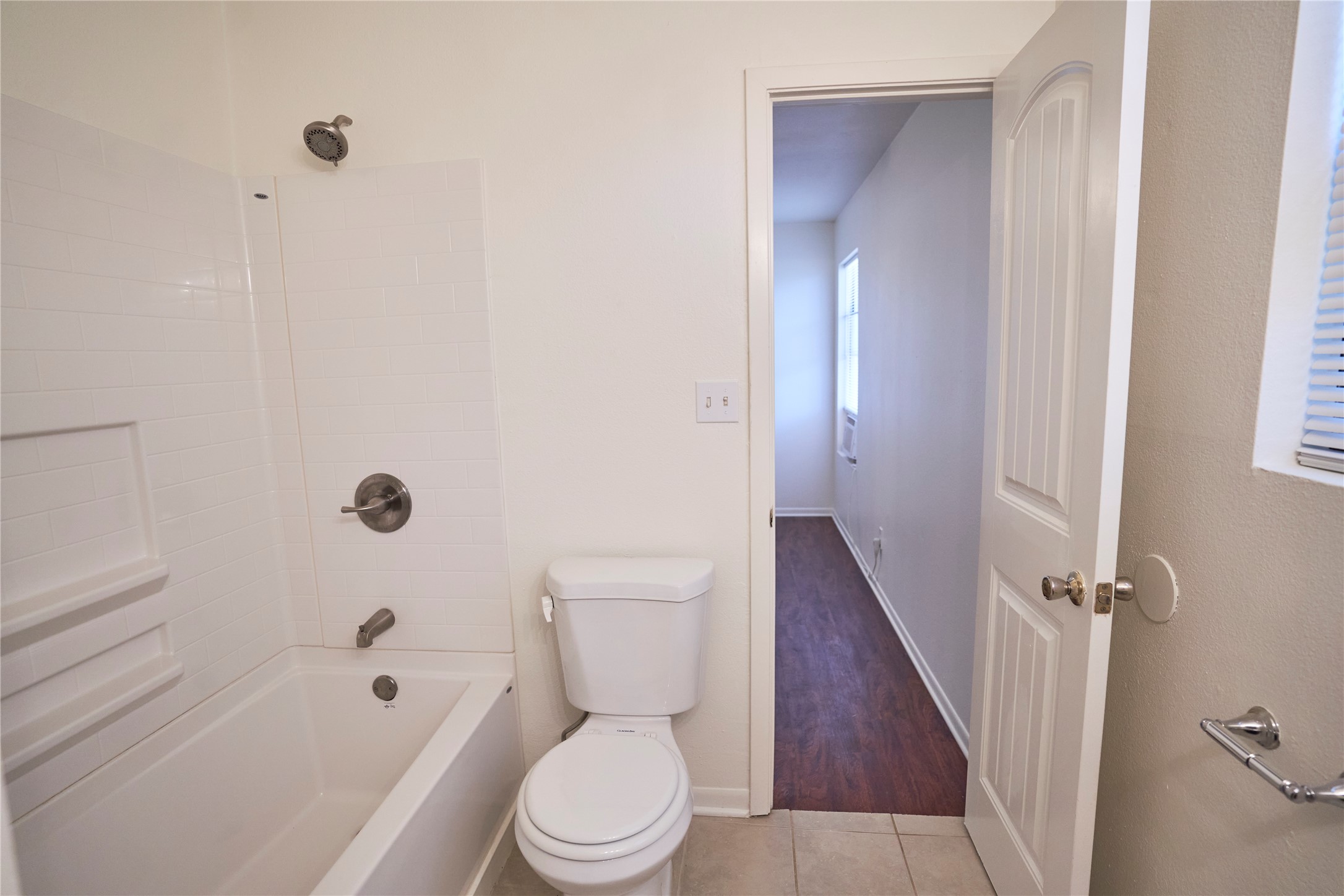 23393 Nameless Road, Unit 171 Leander, TX 78641 - Photo 11 of 15 A pristine bathroom featuring a classic tub and shower combination with white subway tile.