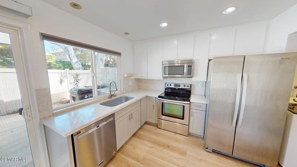 588 Rio Grande Circle Thousand Oaks, CA 91360 - Photo 11 of 30 a kitchen with stainless steel appliances a refrigerator sink and stove