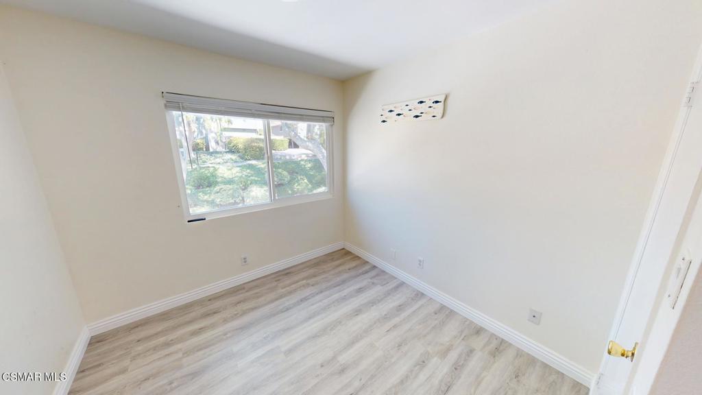 588 Rio Grande Circle Thousand Oaks, CA 91360 - Photo 16 of 30 an empty room with wooden floor and windows