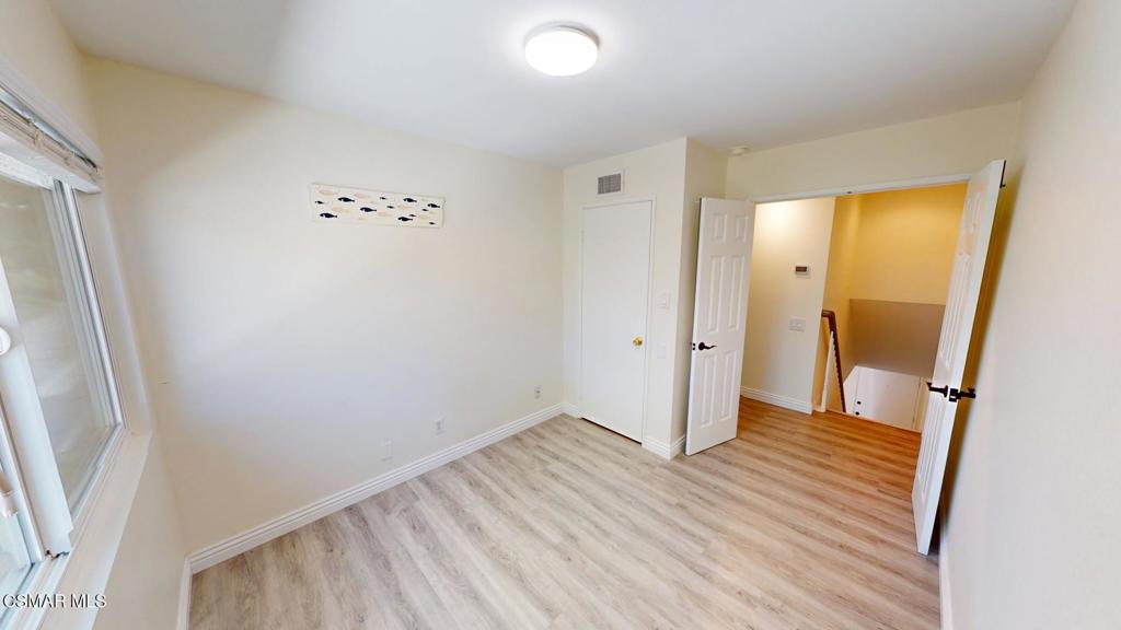 588 Rio Grande Circle Thousand Oaks, CA 91360 - Photo 17 of 30 a view of an empty room with wooden floor and a mirror