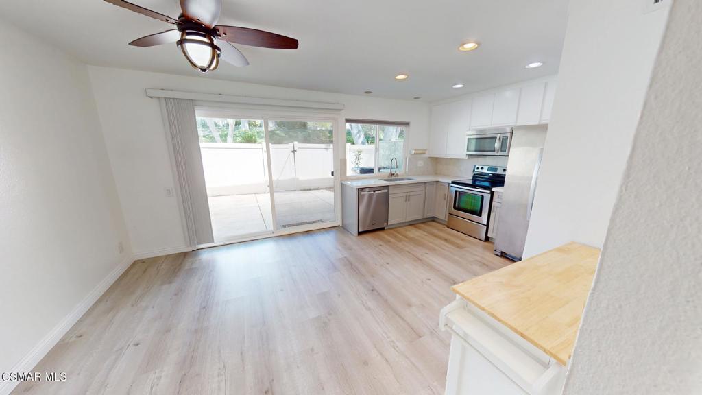 588 Rio Grande Circle Thousand Oaks, CA 91360 - Photo 9 of 30 a large kitchen with a wooden floor and cabinets