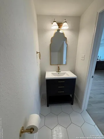 a bathroom with a sink and a mirror