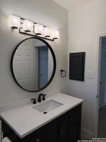 a bathroom with a sink and a mirror
