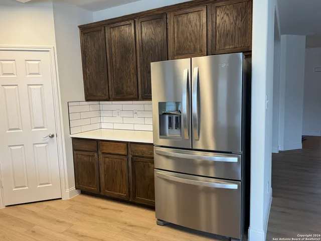 a kitchen with kitchen island wooden cabinets and stainless steel appliances
