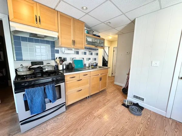 a kitchen with granite countertop a sink appliances and cabinets