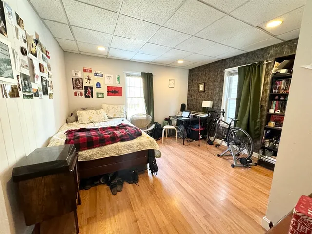 a bedroom with furniture and a wooden floor
