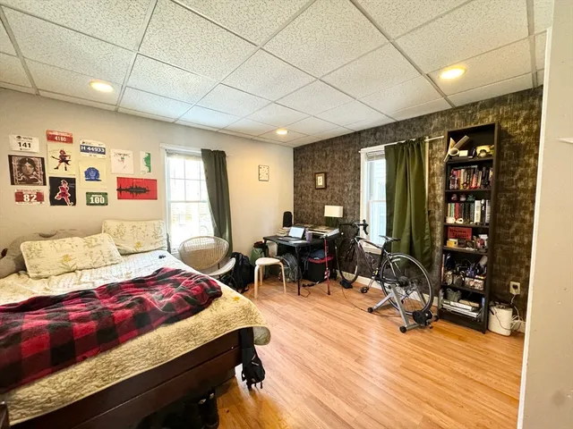 a bedroom with furniture and a wooden floor