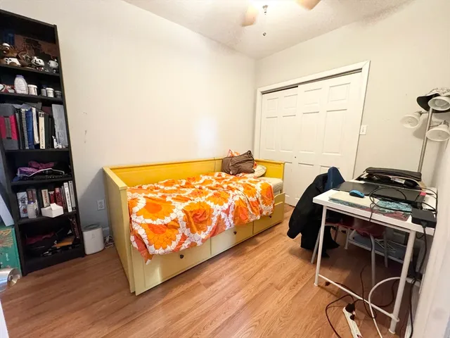 a bedroom with a bed and a book shelf