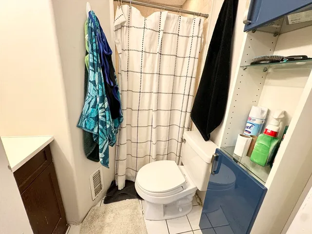 a bathroom with a toilet and a shower