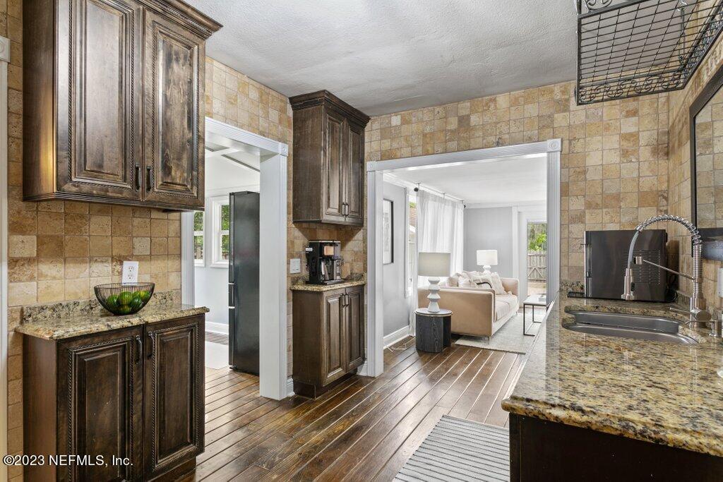 1623 Charon Road Jacksonville, FL 32205 - Photo 14 of 45 a kitchen with refrigerator and cabinets