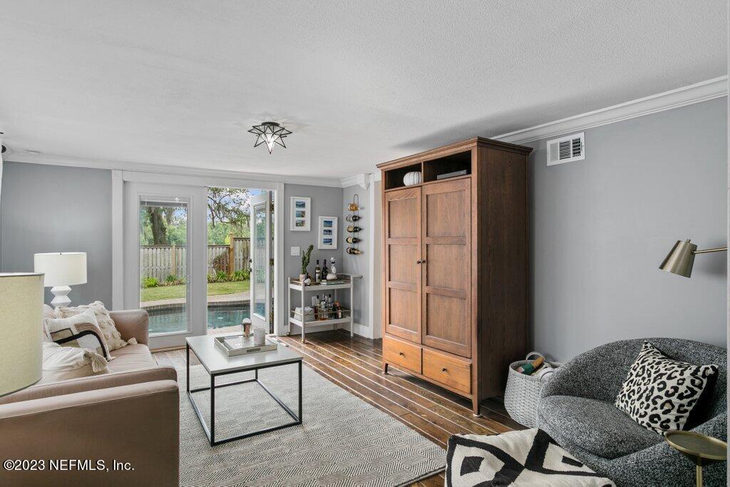1623 Charon Road Jacksonville, FL 32205 - Photo 15 of 45 a living room with furniture and a floor to ceiling window