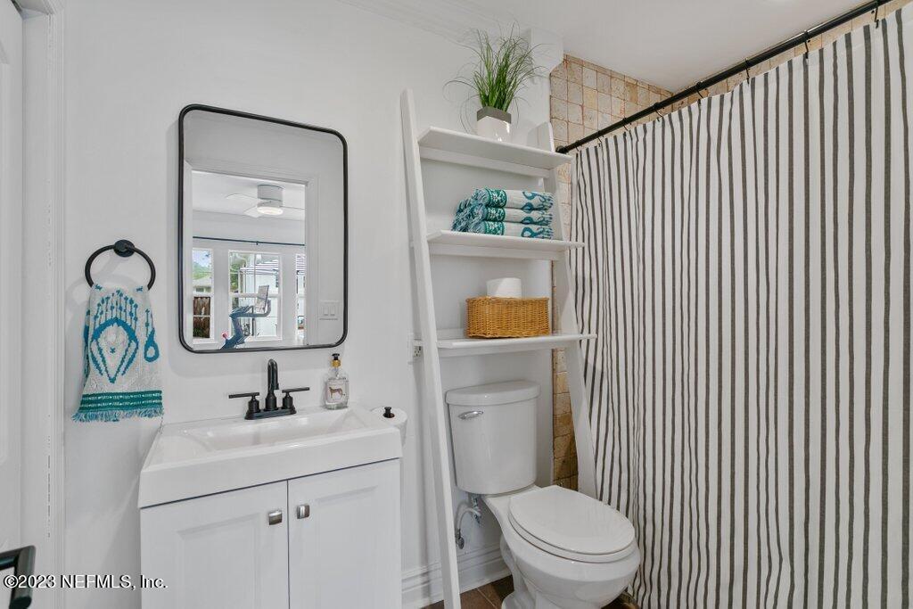 1623 Charon Road Jacksonville, FL 32205 - Photo 24 of 45 a bathroom with a toilet a sink and mirror