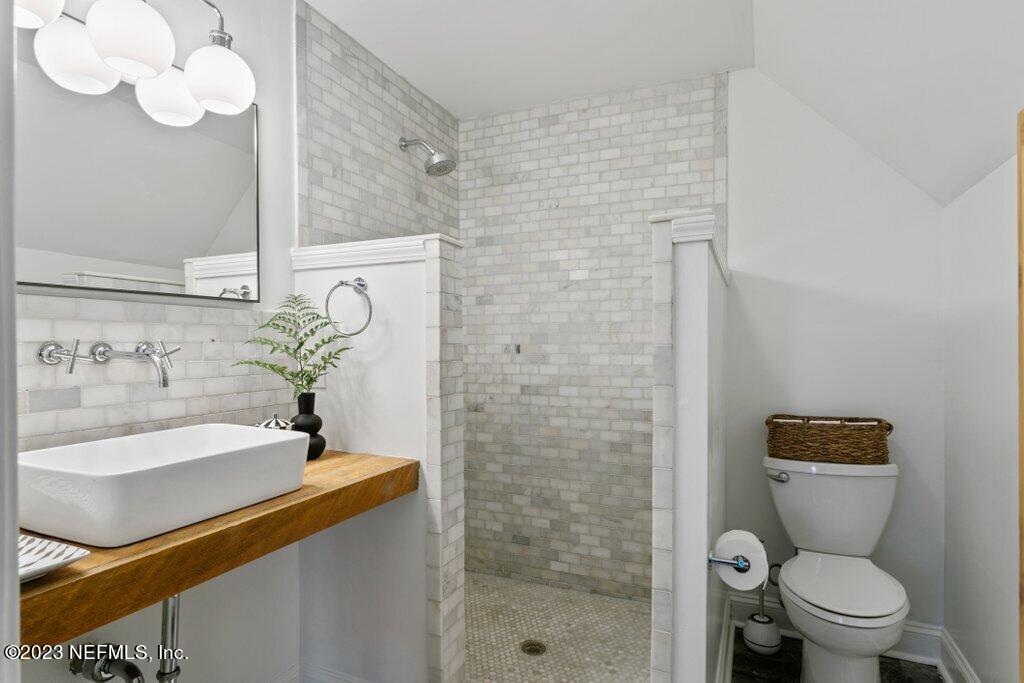 1623 Charon Road Jacksonville, FL 32205 - Photo 33 of 45 a bathroom with a sink a toilet and shower