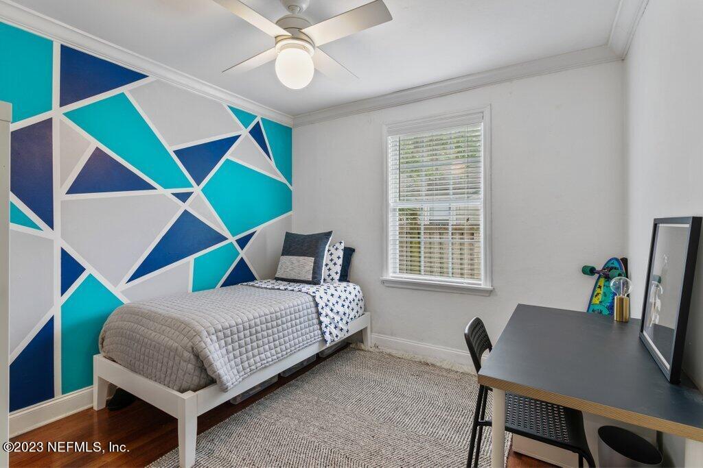 1623 Charon Road Jacksonville, FL 32205 - Photo 38 of 45 a bedroom with a bed and a workspace