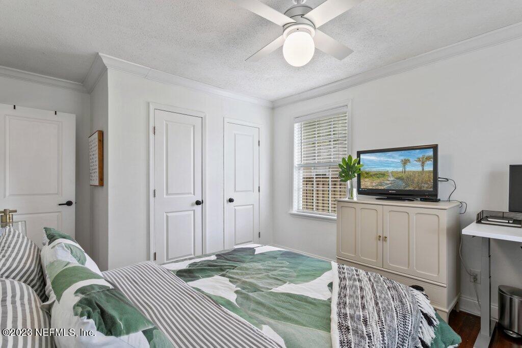 1623 Charon Road Jacksonville, FL 32205 - Photo 41 of 45 a bedroom with a bed and a flat screen tv