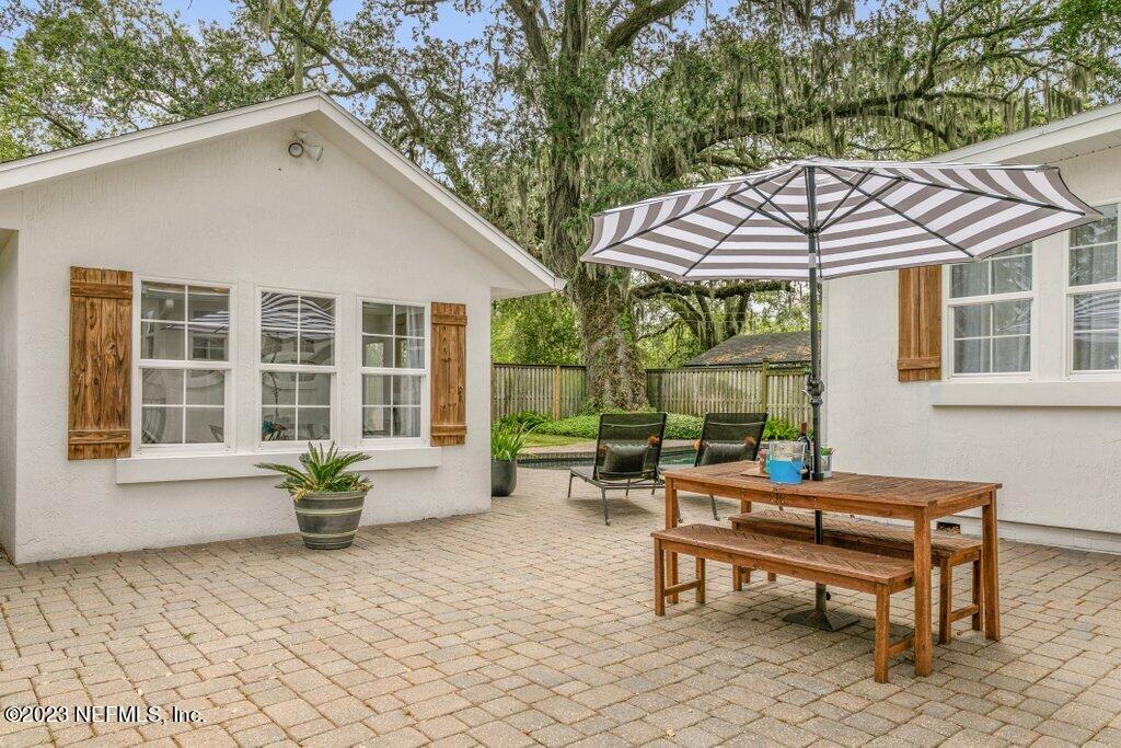 1623 Charon Road Jacksonville, FL 32205 - Photo 43 of 45 a backyard of a house with table and chairs