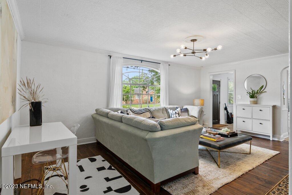 1623 Charon Road Jacksonville, FL 32205 - Photo 6 of 45 a living room with furniture and a chandelier