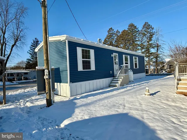 a view of a house with backyard and snow