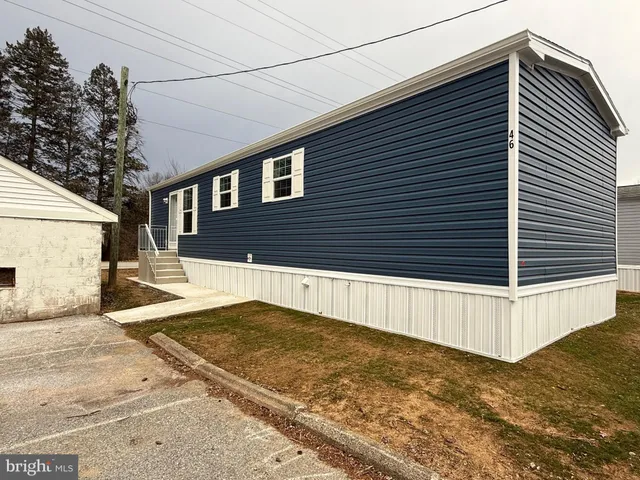 a view of a house with a snow on the road