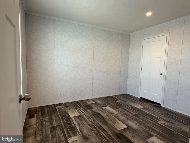 a view of a room with wooden floor