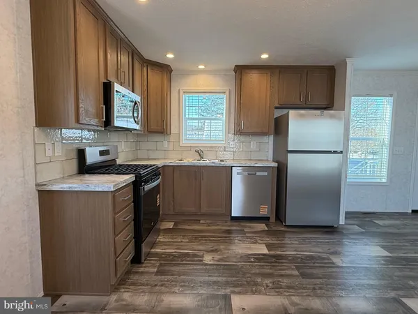 a kitchen with a sink stove and refrigerator