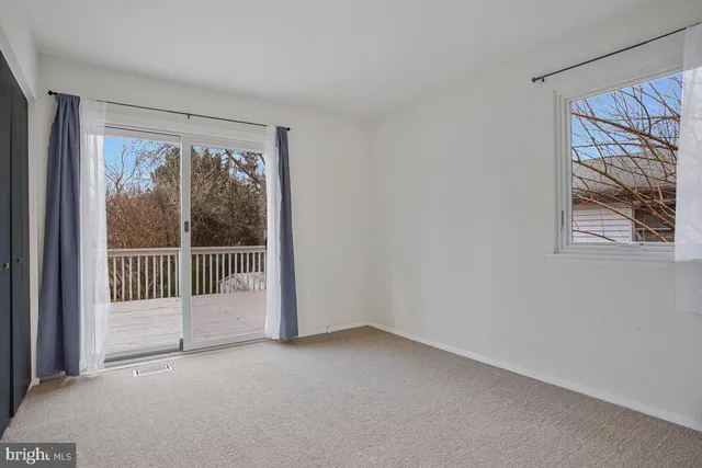 a view of a room with sliding door and wooden floor