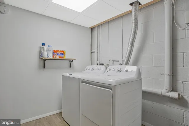 a view of empty room with wooden floor and windows